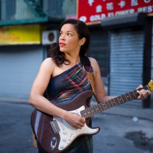 Ebony Tay playing guitar